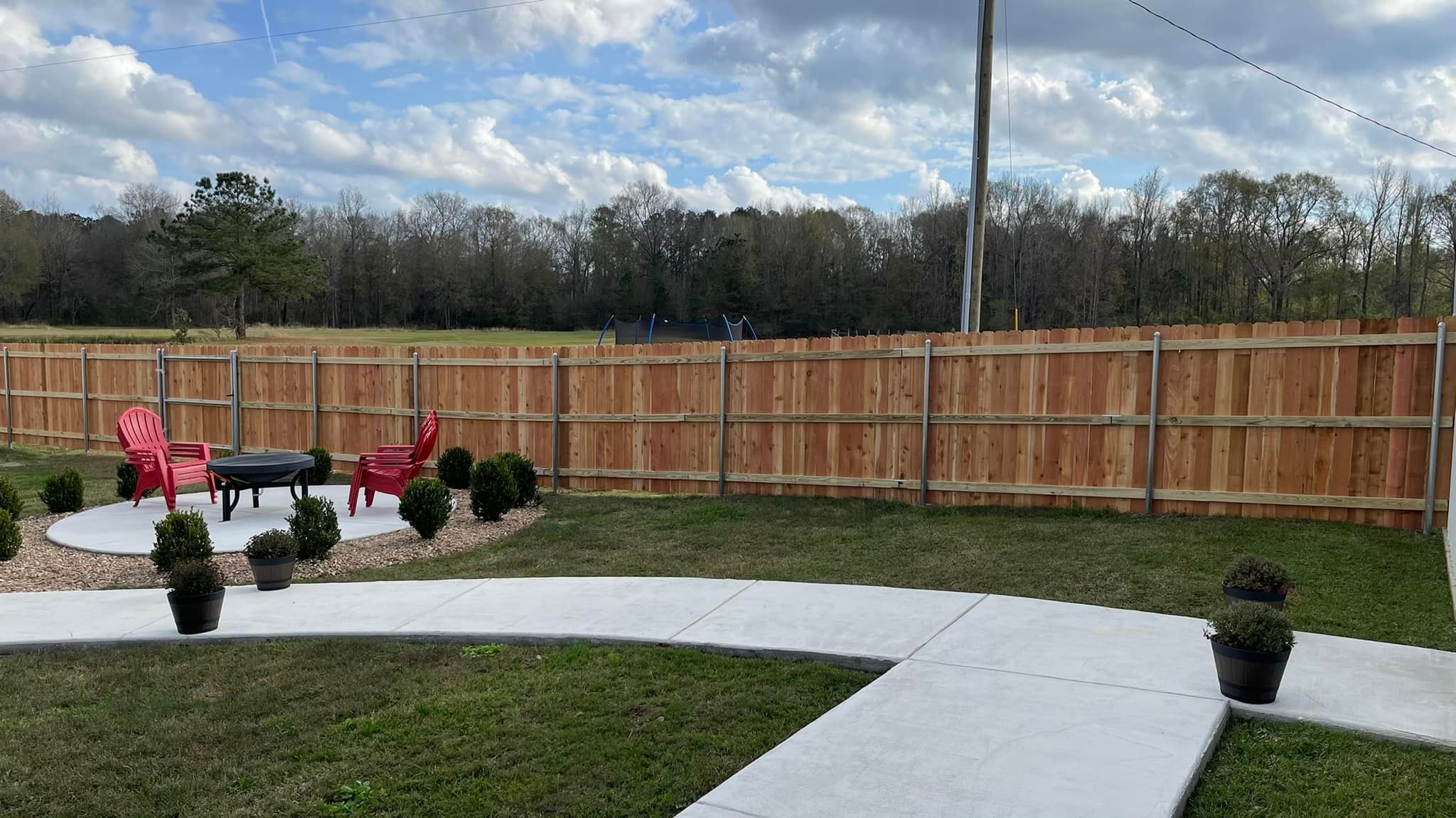 Cedar fence with backyard fire pit area
