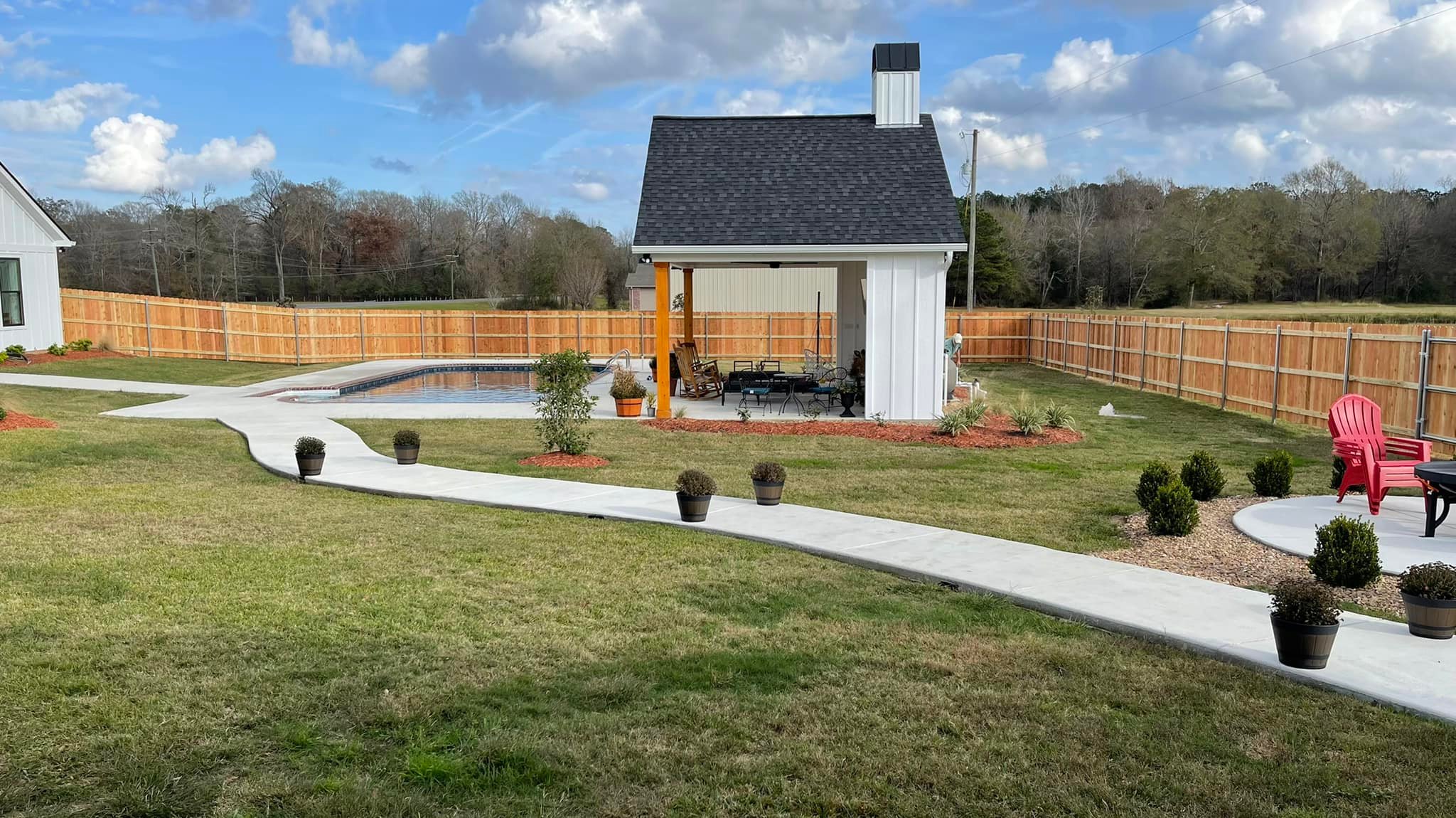 Cedar privacy fence surrounding a pool and pavilion